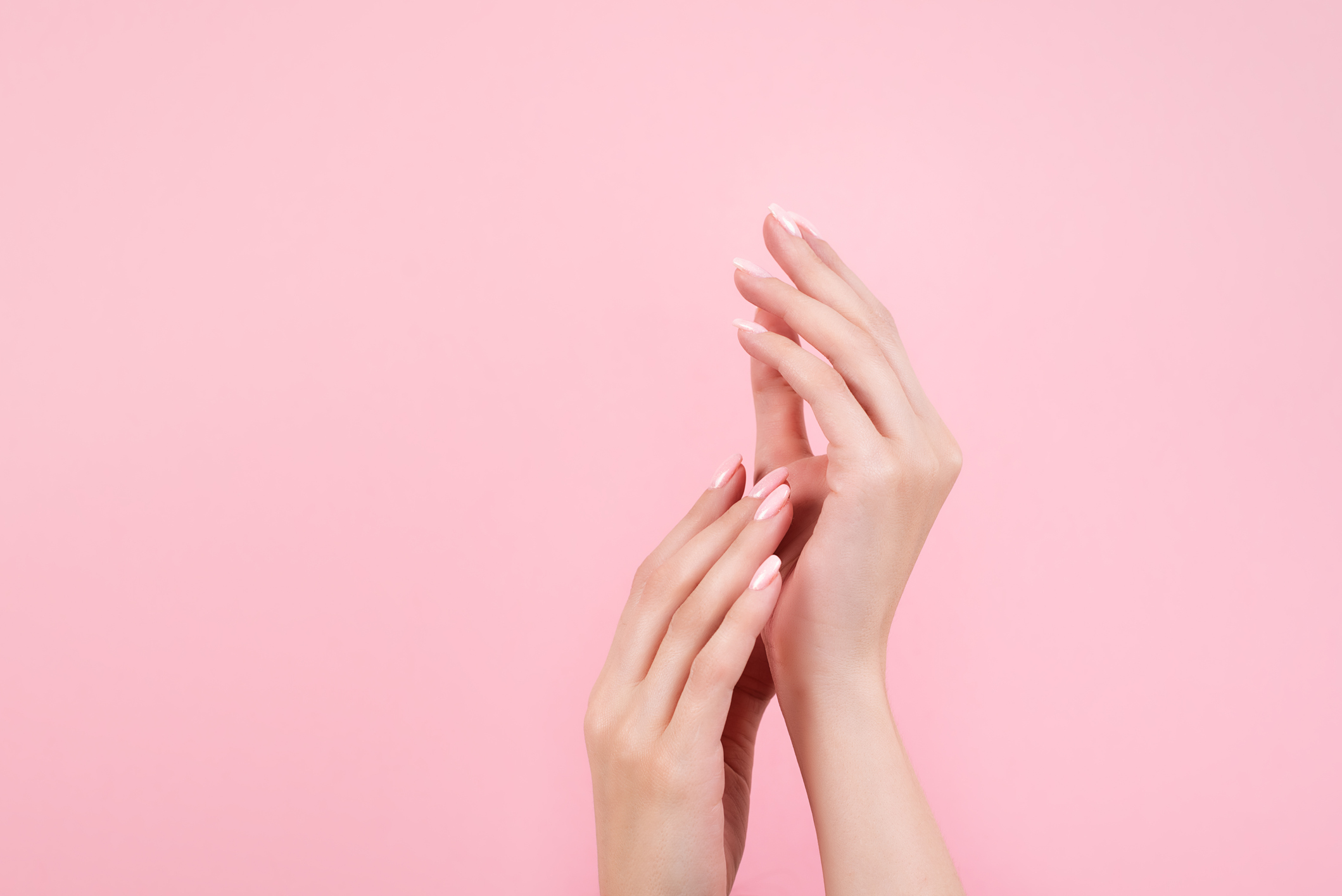 Tender Hands With Perfect Blue And Pink Manicure On Trendy Pastel Pink Background. Place For Text.